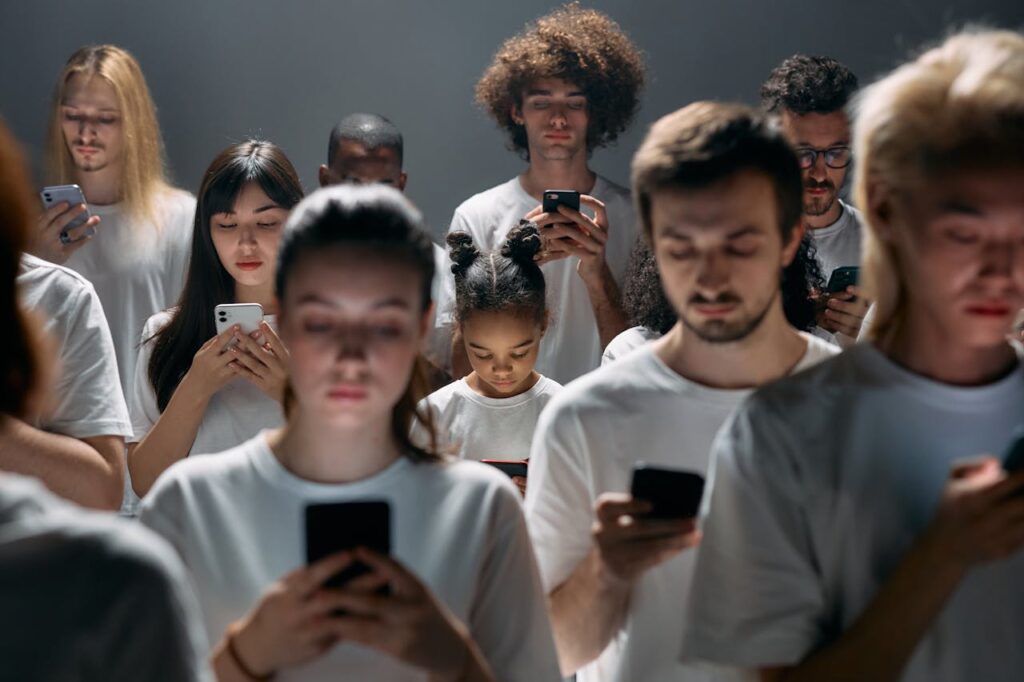 About A diverse group of people engrossed in their smartphones, highlighting modern social connectivity.